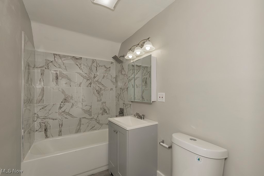 12447 Chillicothe Road Chesterland, OH 44026 - Photo 8 of 42 Full bathroom with vanity, tiled shower / bath combo, and toilet