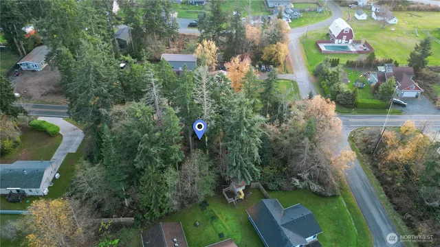 an aerial view of a house with a yard