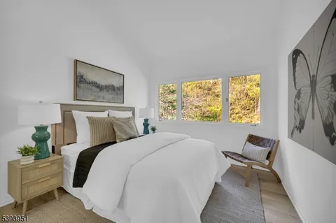 a bedroom with a bed and a large window