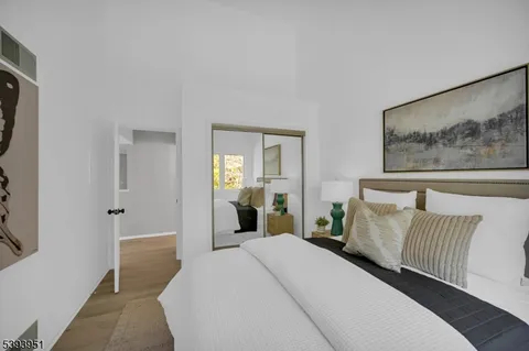 a bedroom with a bed and glass windows