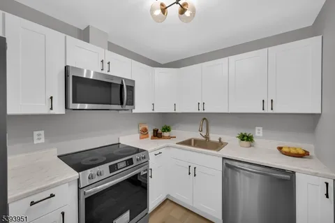 a kitchen with a sink a stove and cabinets