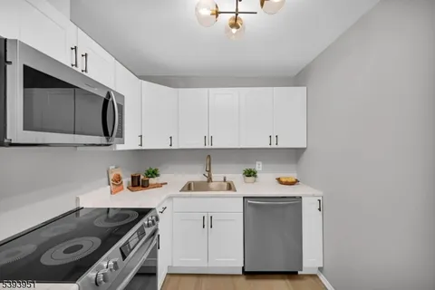 a kitchen with a sink stove and cabinets