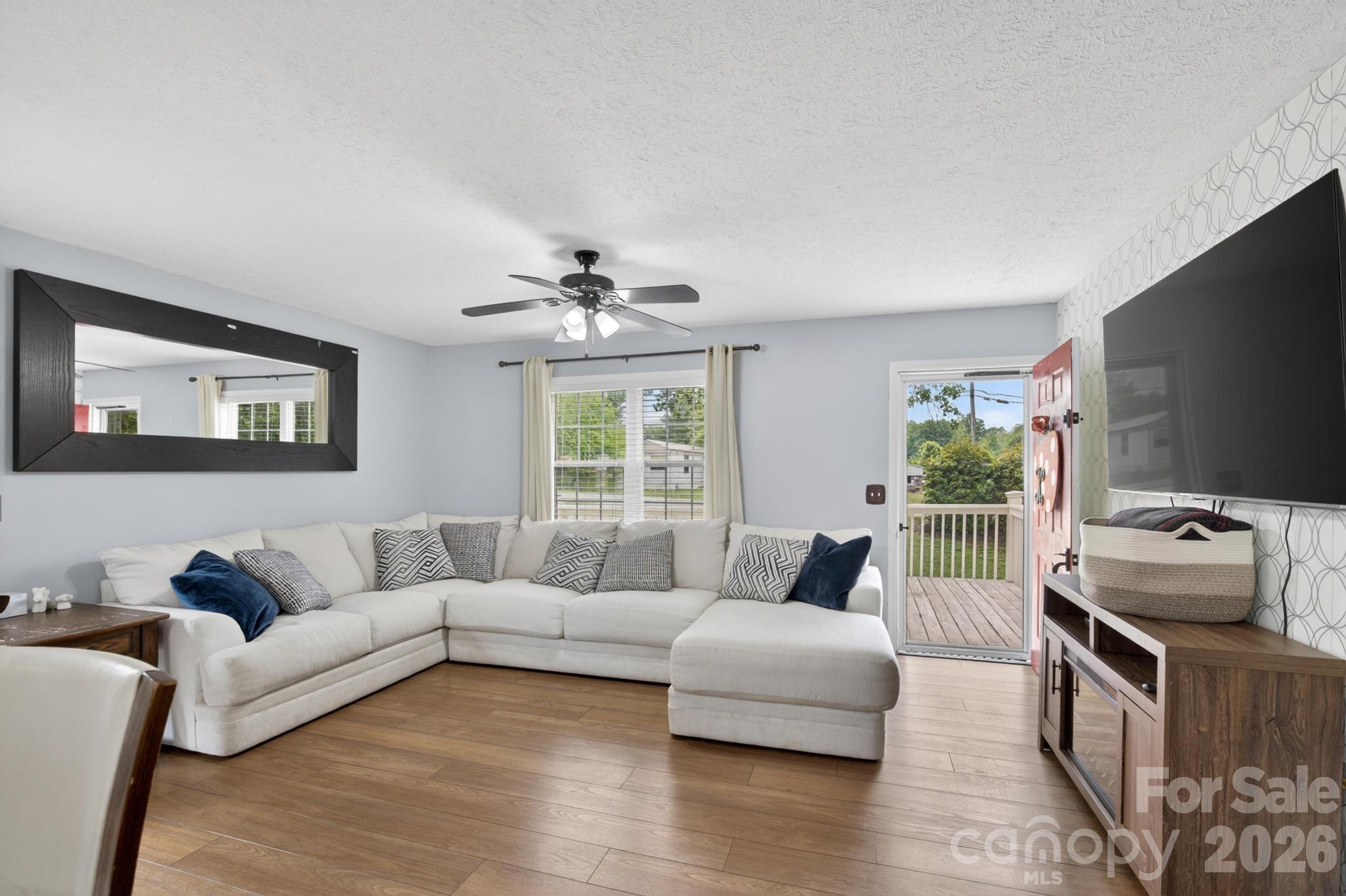 2308 Walt Arney Road Lenoir, NC 28645 - Photo 25 of 37 a living room with furniture and a flat screen tv