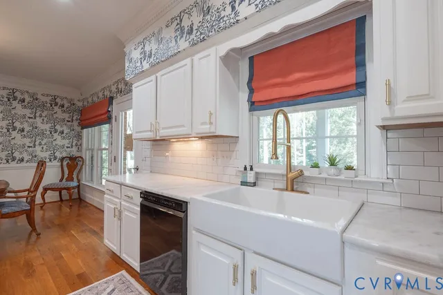 a spacious bedroom with a large bed and a chandelier