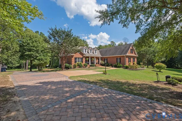 a view of a dining room with furniture and a chandelier