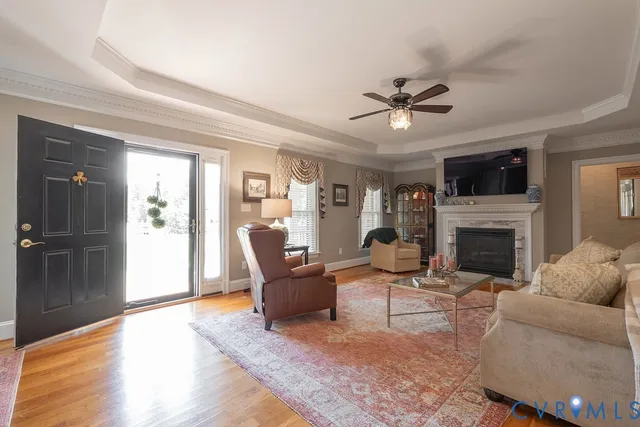 a kitchen with stainless steel appliances granite countertop a stove top oven a sink dishwasher and a fireplace with wooden floor