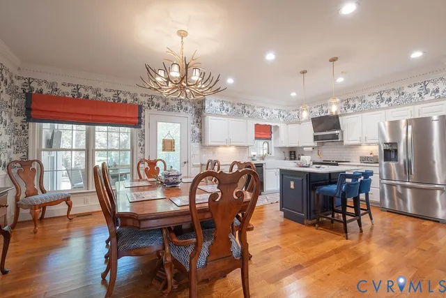 a kitchen with stainless steel appliances granite countertop a sink stove and microwave