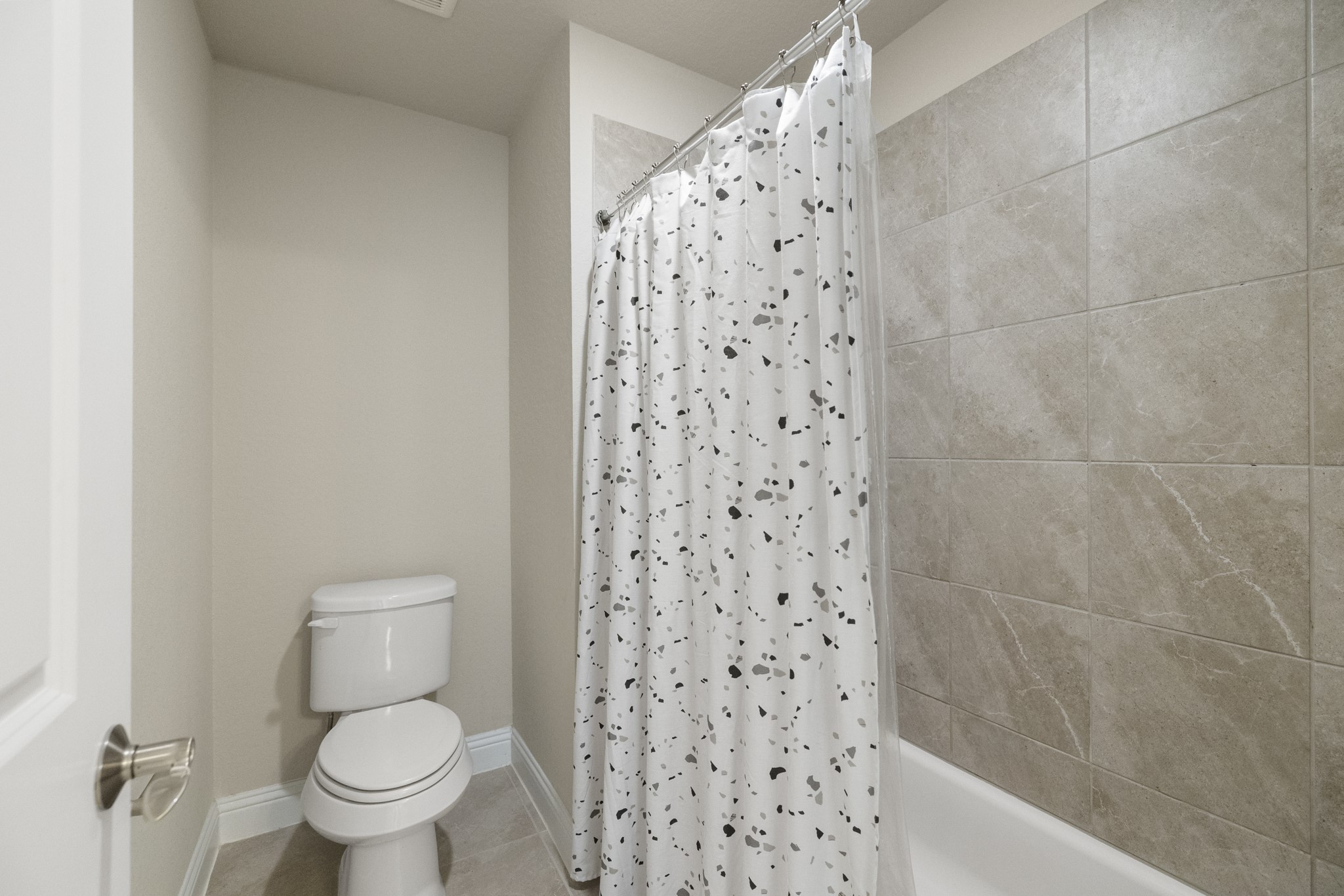7502 Windsor Park Court Spring, TX 77379 - Photo 30 of 50 a a bathroom with a toilet and a shower curtain