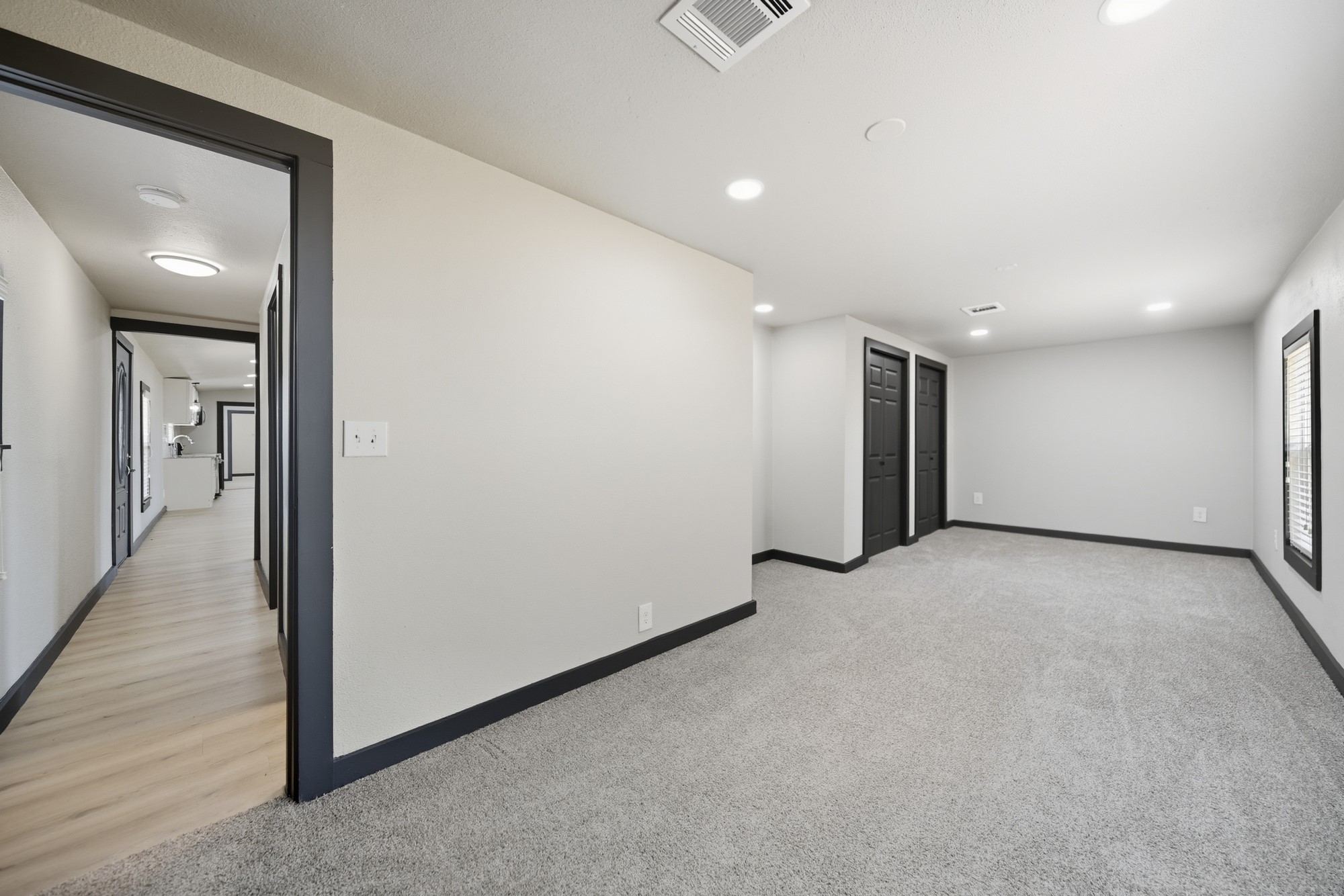 9137 Conner Road Washington, TX 77880 - Photo 28 of 49 a view of a hallway with wooden floor and a bathroom