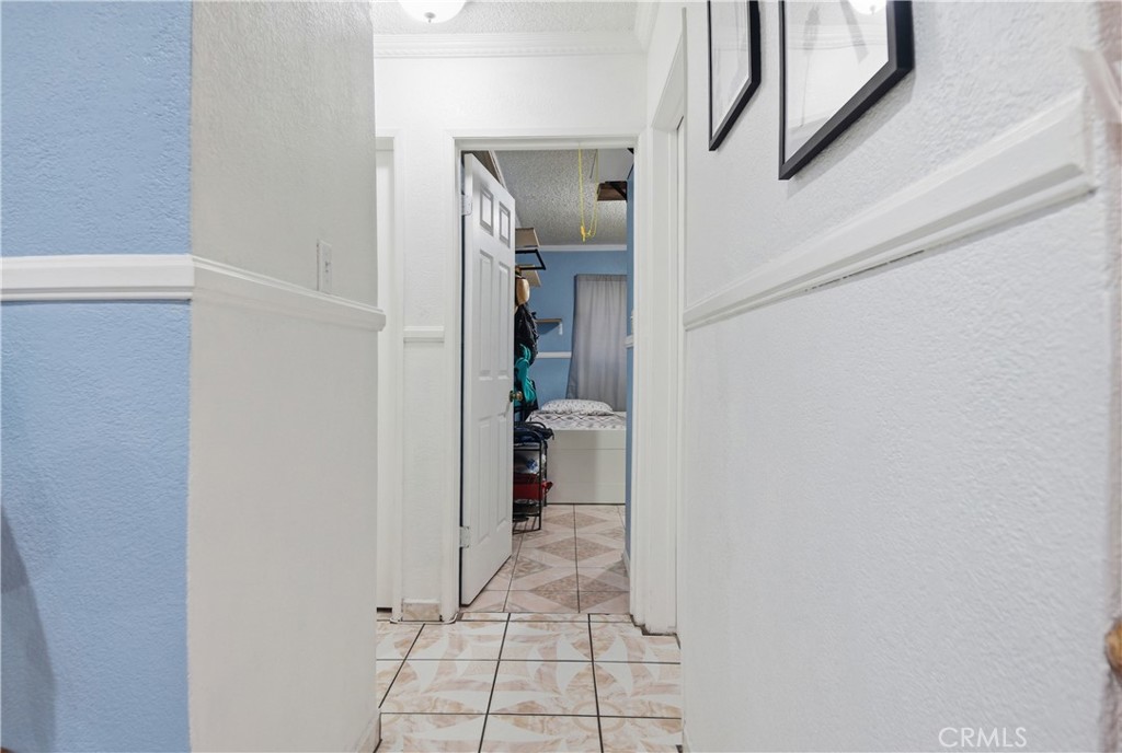 3301 Santa Fe Avenue, Unit 49 Long Beach, CA 90810 - Photo 13 of 26 a view of a hallway with wooden shelves