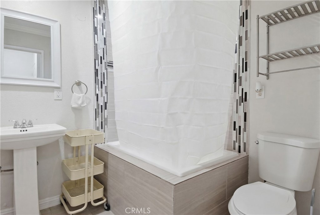 3301 Santa Fe Avenue, Unit 49 Long Beach, CA 90810 - Photo 17 of 26 a bathroom with a sink a toilet and shower
