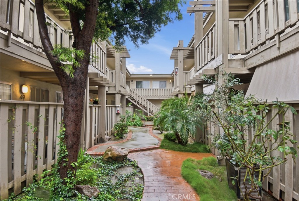 3301 Santa Fe Avenue, Unit 49 Long Beach, CA 90810 - Photo 23 of 26 a view of a street with potted plants and more windows