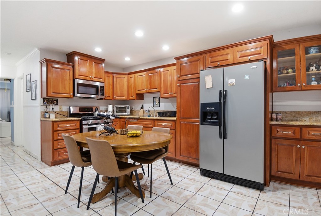 3301 Santa Fe Avenue, Unit 49 Long Beach, CA 90810 - Photo 4 of 26 a kitchen with stainless steel appliances granite countertop a refrigerator and a stove top oven