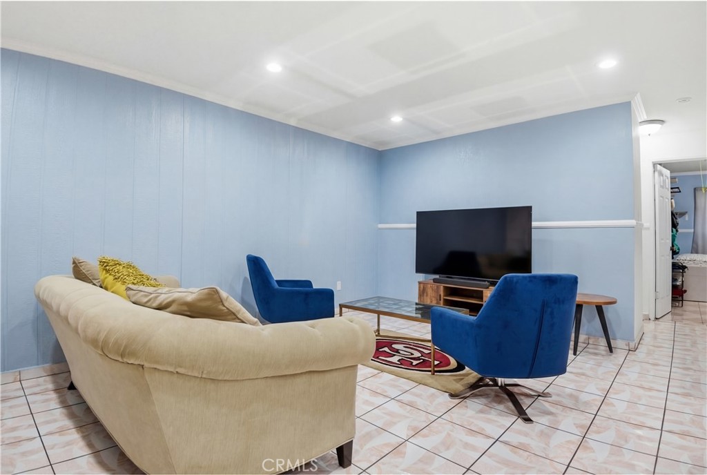 3301 Santa Fe Avenue, Unit 49 Long Beach, CA 90810 - Photo 7 of 26 a living room with furniture and a flat screen tv