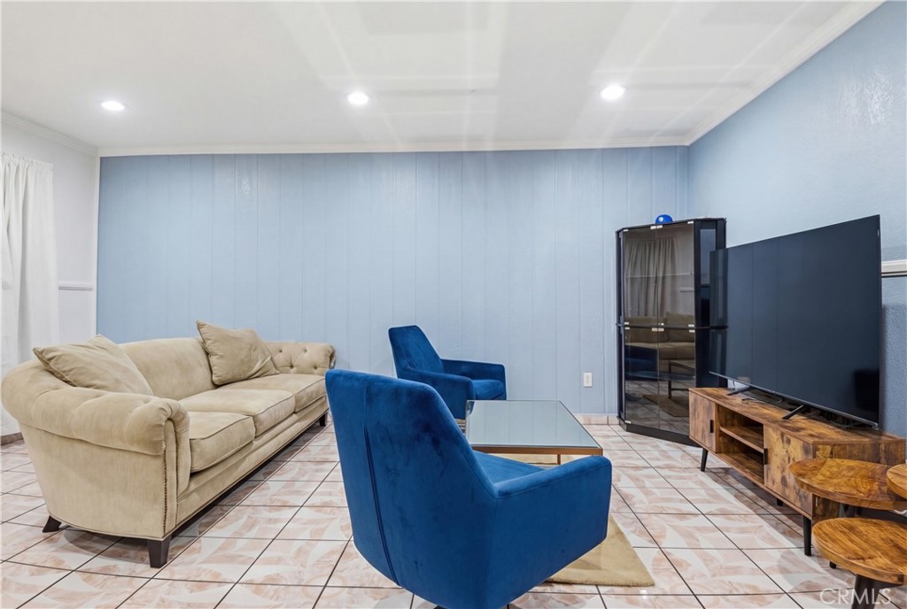 3301 Santa Fe Avenue, Unit 49 Long Beach, CA 90810 - Photo 8 of 26 a living room with furniture and a flat screen tv