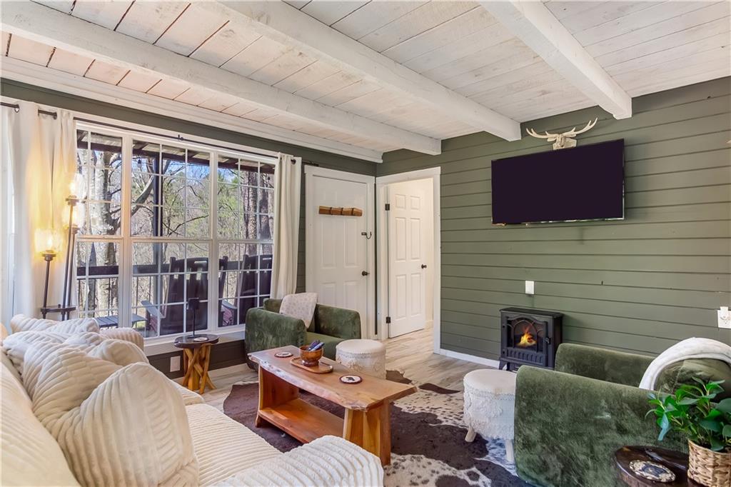 2308 Carver Mill Road Talking Rock, GA 30175 - Photo 8 of 33 a living room with furniture and a floor to ceiling window