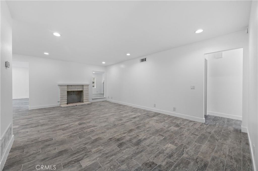 18578 Fieldbrook Street Rowland Heights, CA 91748 - Photo 3 of 20 an empty room with wooden floor and fireplace