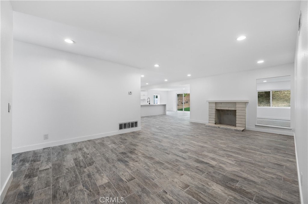 18578 Fieldbrook Street Rowland Heights, CA 91748 - Photo 4 of 20 an empty room with wooden floor and fireplace