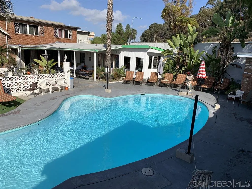3517 E Street San Diego, CA 92102 - Photo 4 of 15 a view of a patio with dining table and chairs under an umbrella