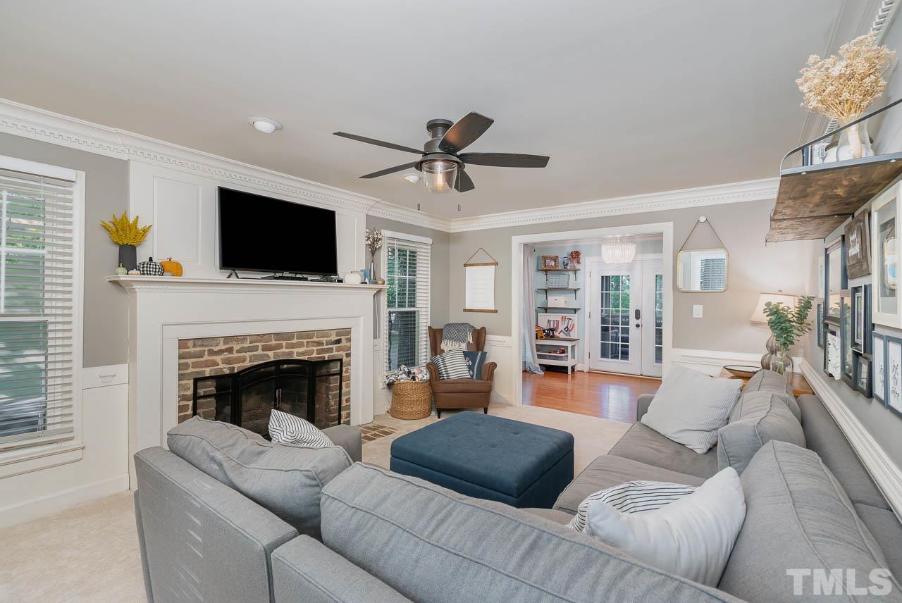 108 Donna Place Cary, NC 27513 - Photo 11 of 30 a living room with furniture a fireplace and a flat screen tv