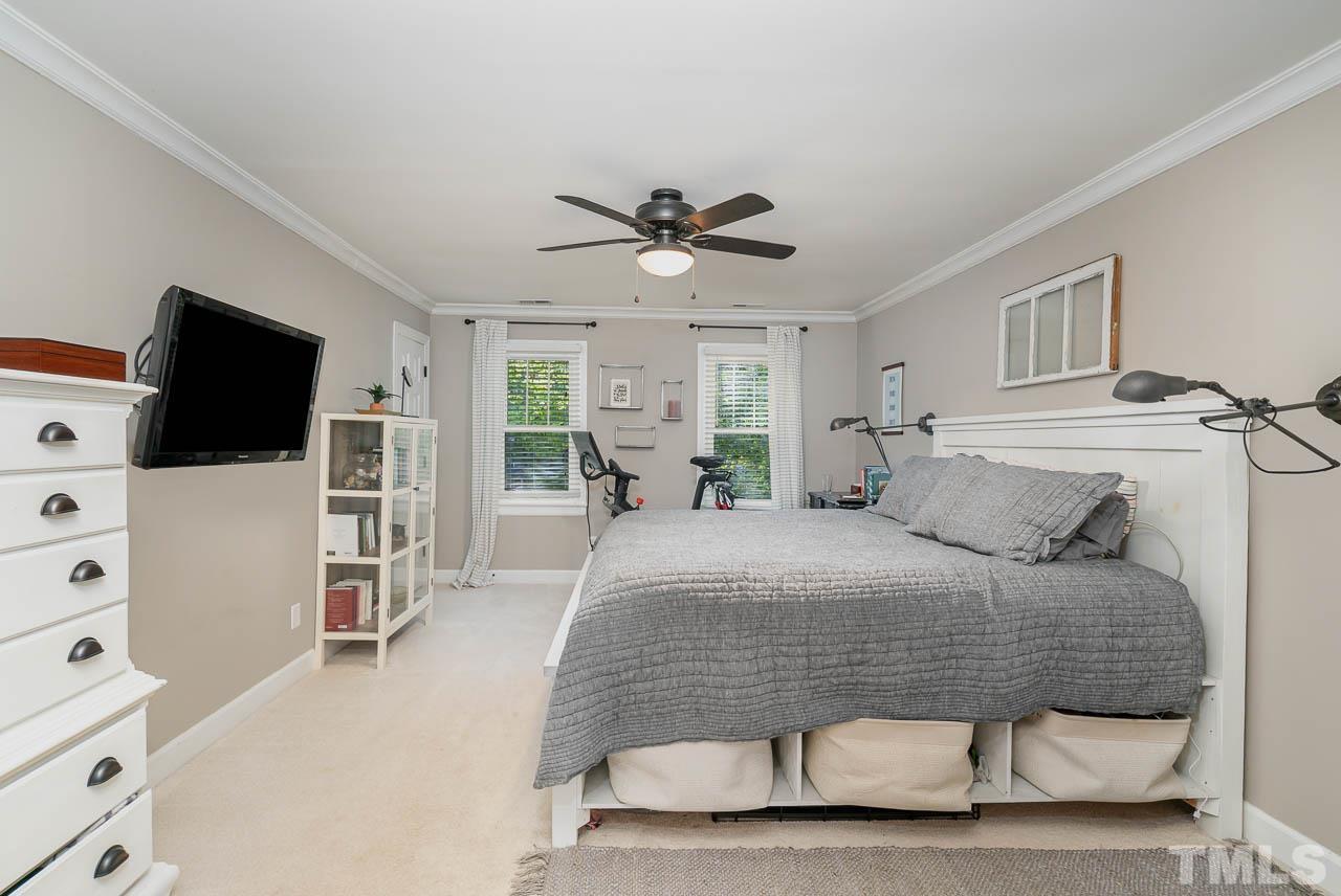 108 Donna Place Cary, NC 27513 - Photo 16 of 30 a bedroom with a bed and a flat screen tv