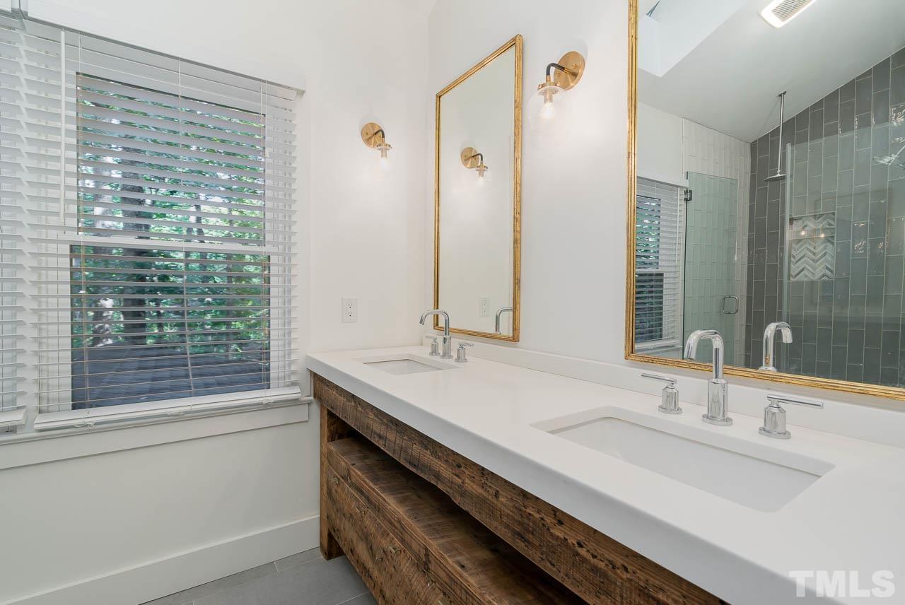 108 Donna Place Cary, NC 27513 - Photo 18 of 30 a bathroom with a granite countertop sink and a large mirror