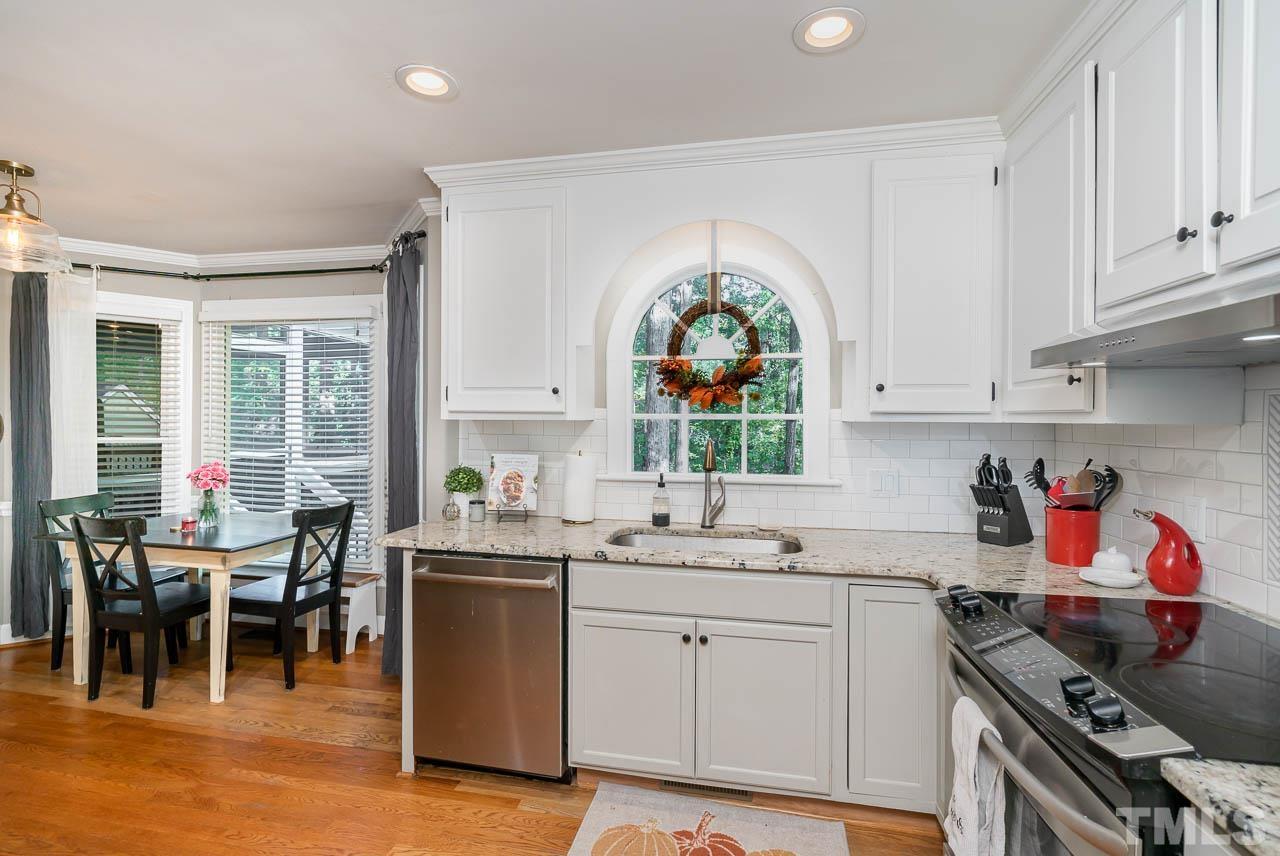 108 Donna Place Cary, NC 27513 - Photo 6 of 30 a kitchen with a sink stove and cabinets