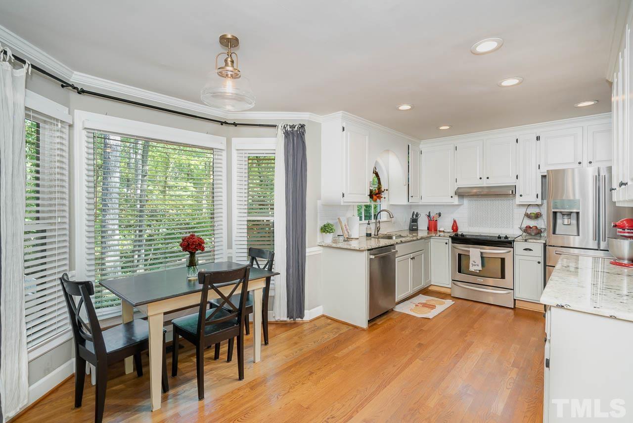 108 Donna Place Cary, NC 27513 - Photo 7 of 30 a kitchen with a table chairs stove and cabinets