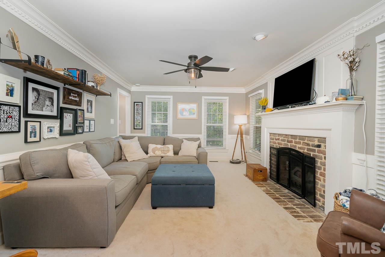 108 Donna Place Cary, NC 27513 - Photo 10 of 30 a living room with furniture a flat screen tv and a fireplace