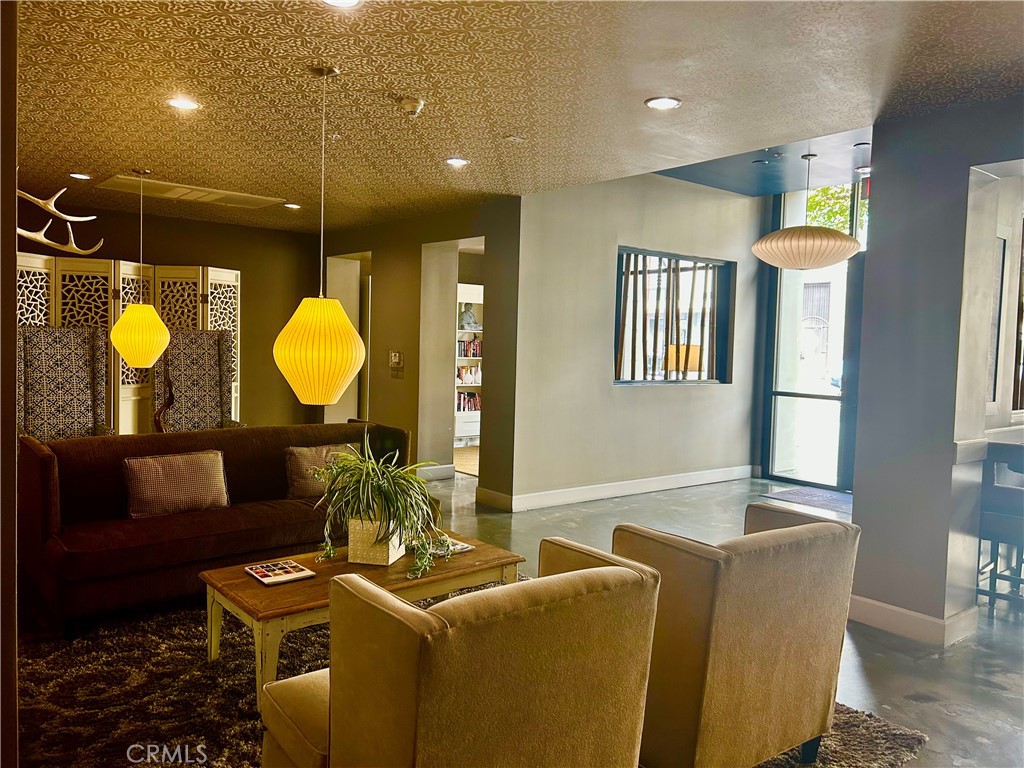 300 East 4th Street, Unit 101 Long Beach, CA 90802 - Photo 31 of 64 a living room with furniture and a mirror