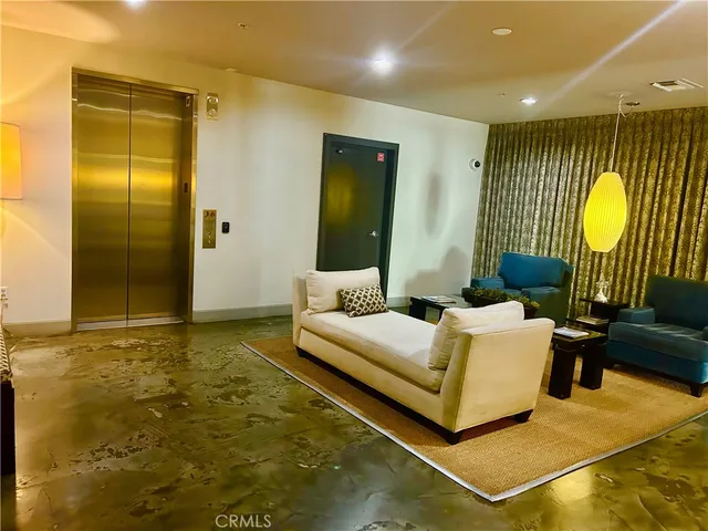 a room with gym equipment and large windows