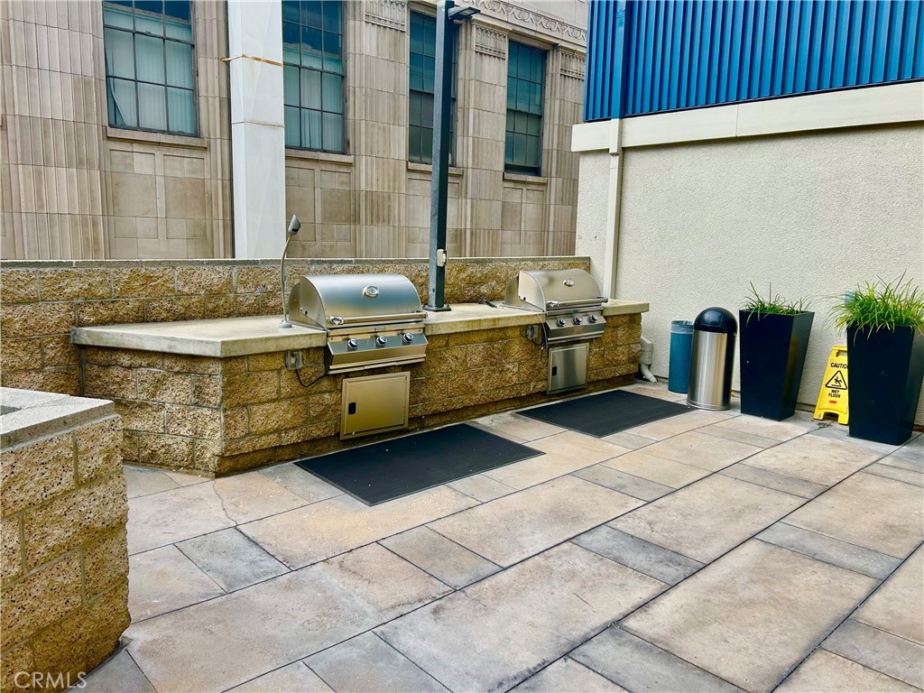 300 East 4th Street, Unit 101 Long Beach, CA 90802 - Photo 64 of 64 a view of a kitchen with a sink and a refrigerator