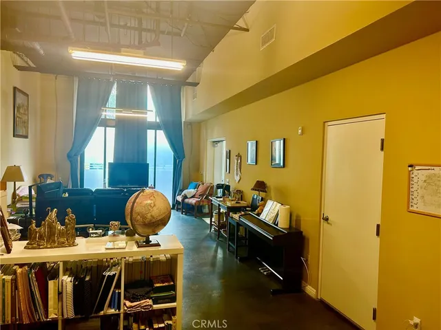 a living room with furniture and a book shelf
