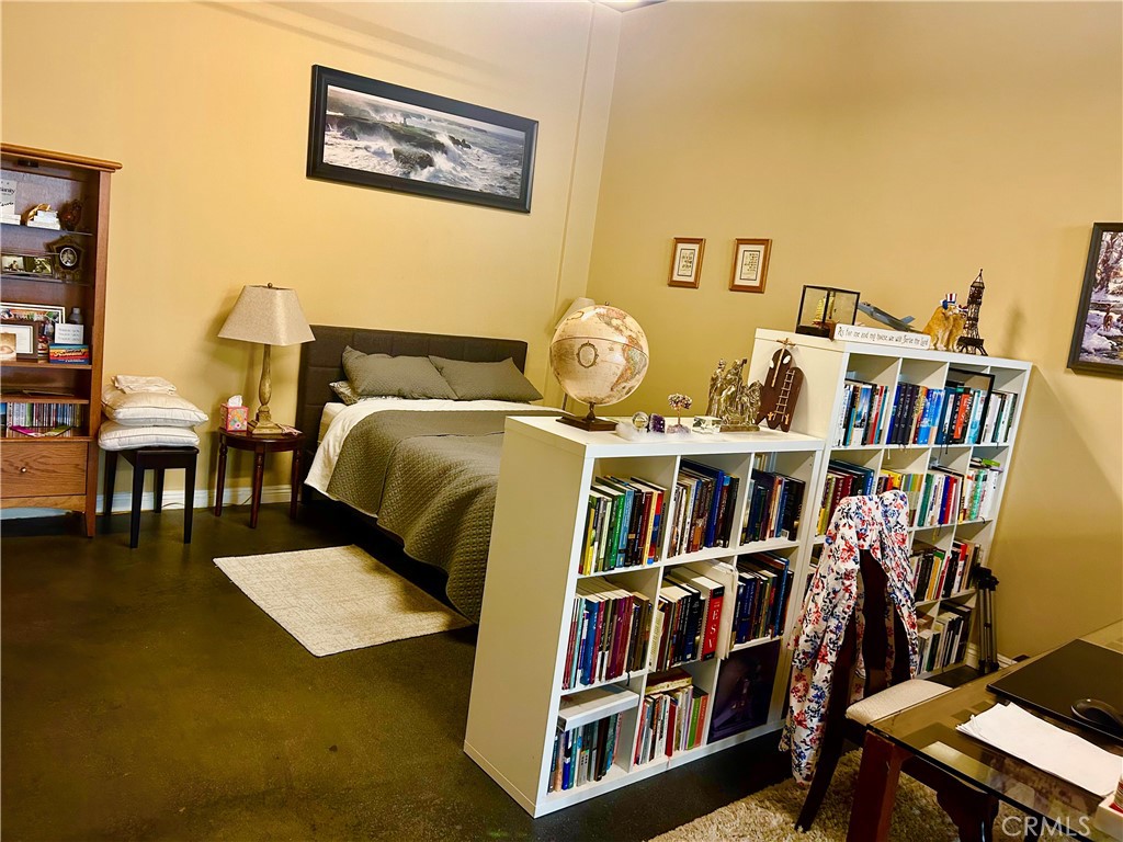300 East 4th Street, Unit 101 Long Beach, CA 90802 - Photo 9 of 64 a living room with furniture and a book shelf