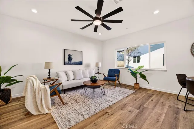 a living room with furniture and wooden floor
