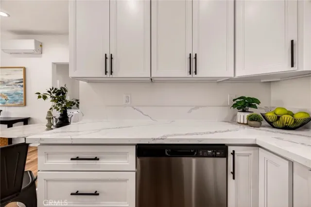 a view of a hallway with wooden floor table and chairs