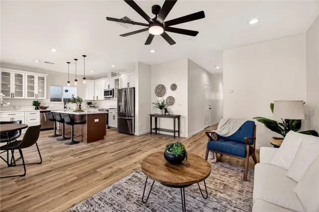 a living room with lots of furniture and kitchen view