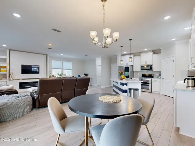 a view of a dining room that has a table and chairs
