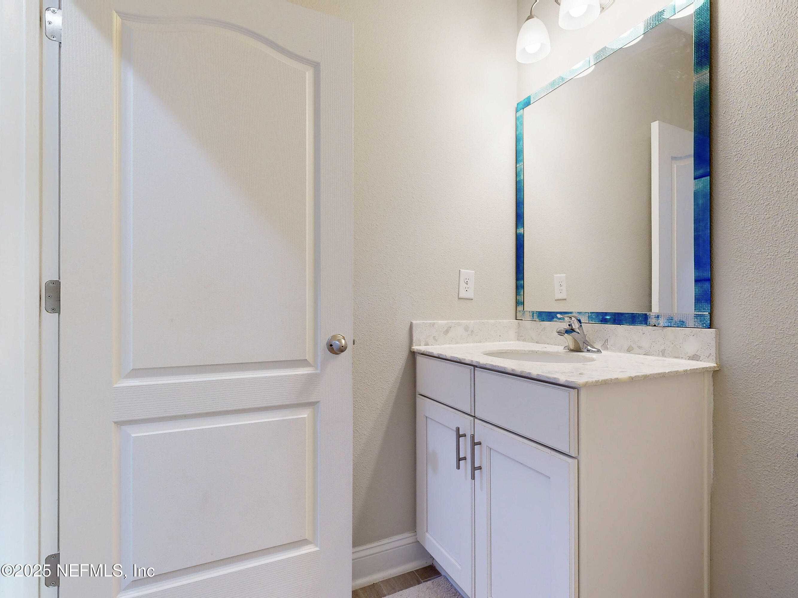 210 Thistleton Way Street St. Augustine, FL 32092 - Photo 12 of 38 a bathroom with a sink and a mirror