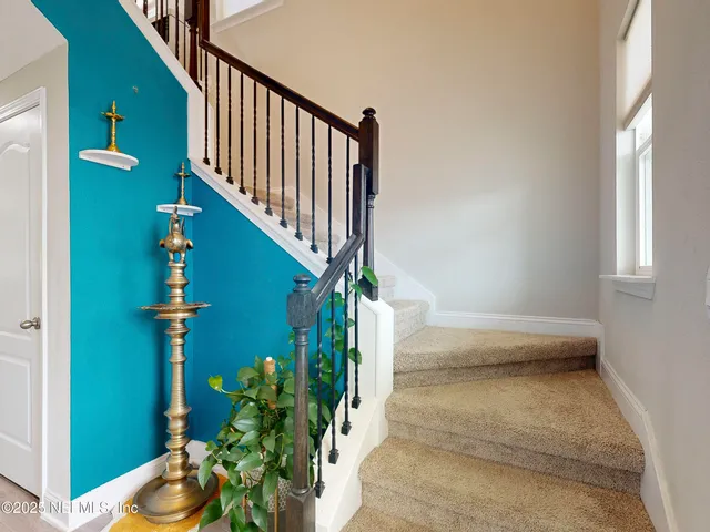 a view of staircase with wooden floor and a potted plant