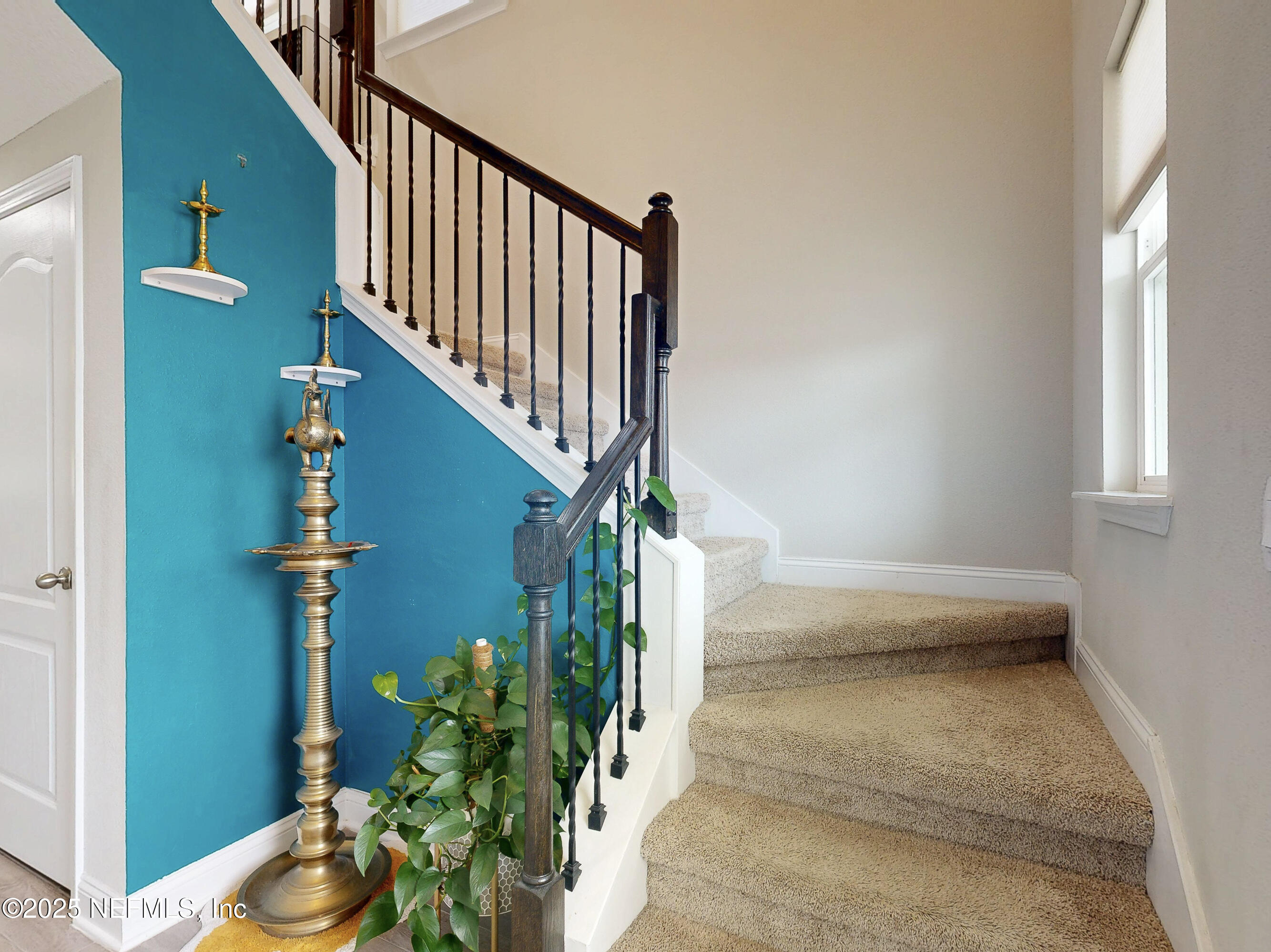 210 Thistleton Way Street St. Augustine, FL 32092 - Photo 13 of 38 a view of staircase with wooden floor and a potted plant