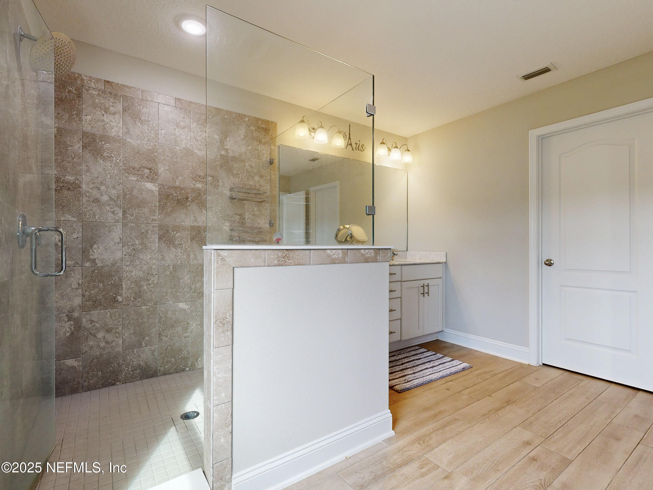 210 Thistleton Way Street St. Augustine, FL 32092 - Photo 22 of 38 a bathroom with a sink a mirror and a shower