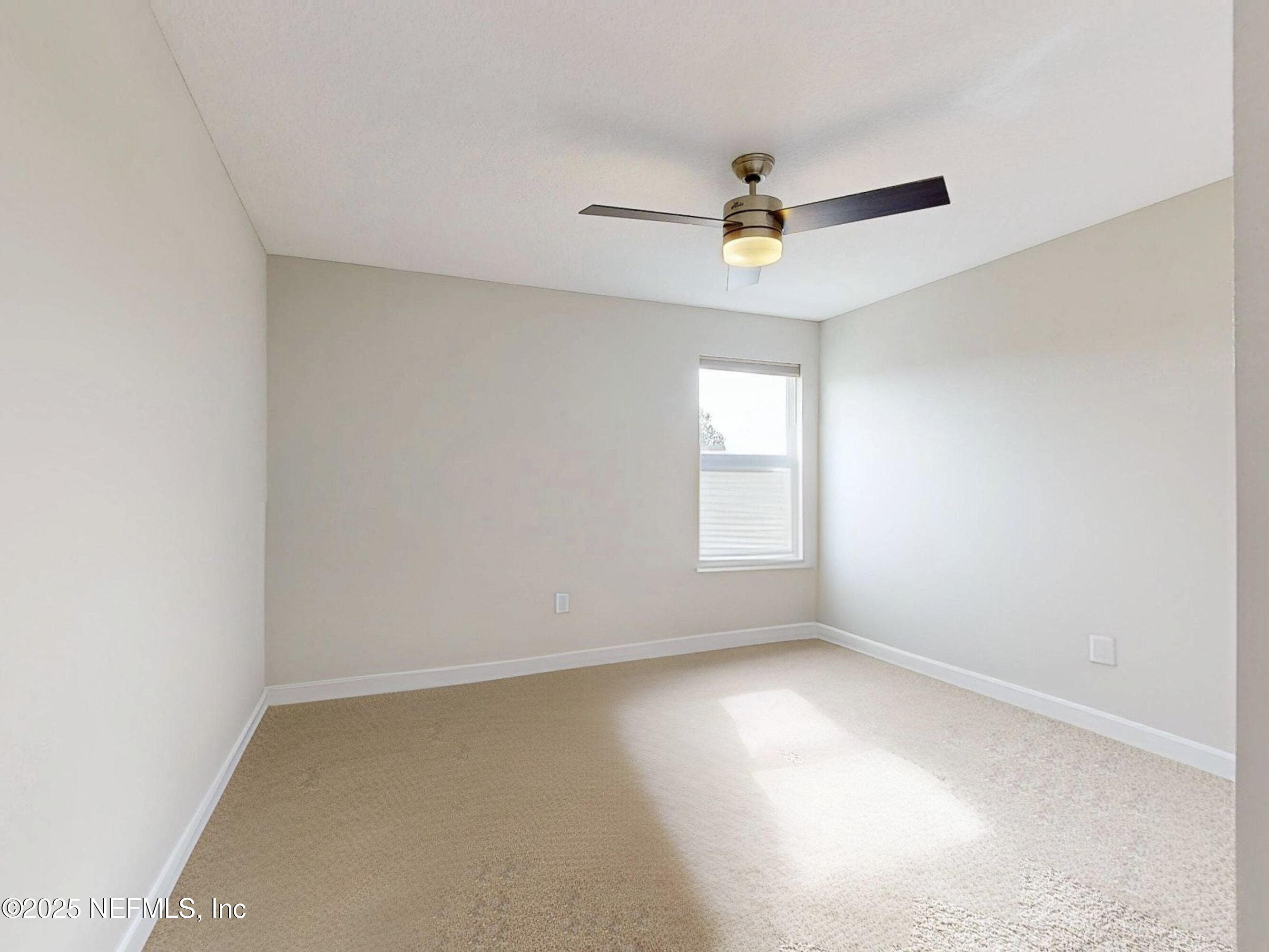 210 Thistleton Way Street St. Augustine, FL 32092 - Photo 25 of 38 an empty room with a window and a ceiling fan