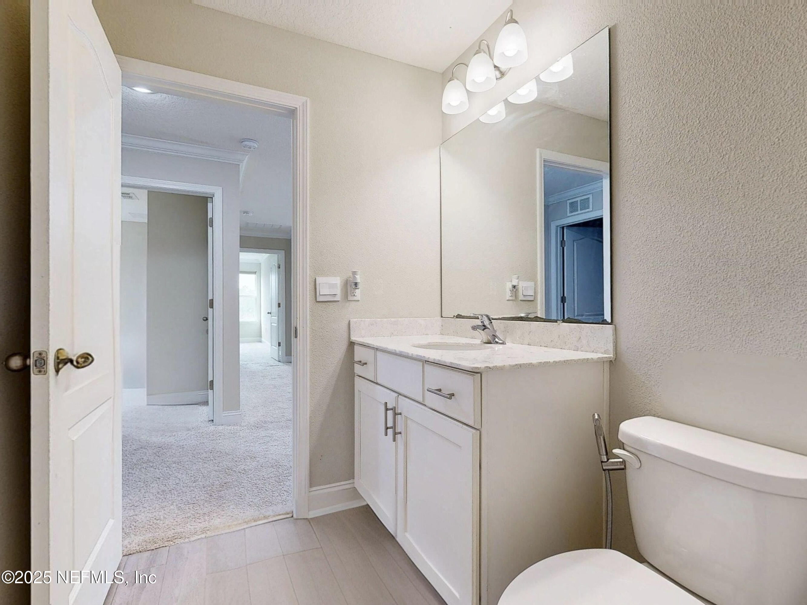 210 Thistleton Way Street St. Augustine, FL 32092 - Photo 27 of 38 a bathroom with a sink a toilet and a mirror