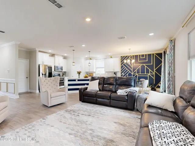 a living room with furniture and kitchen view
