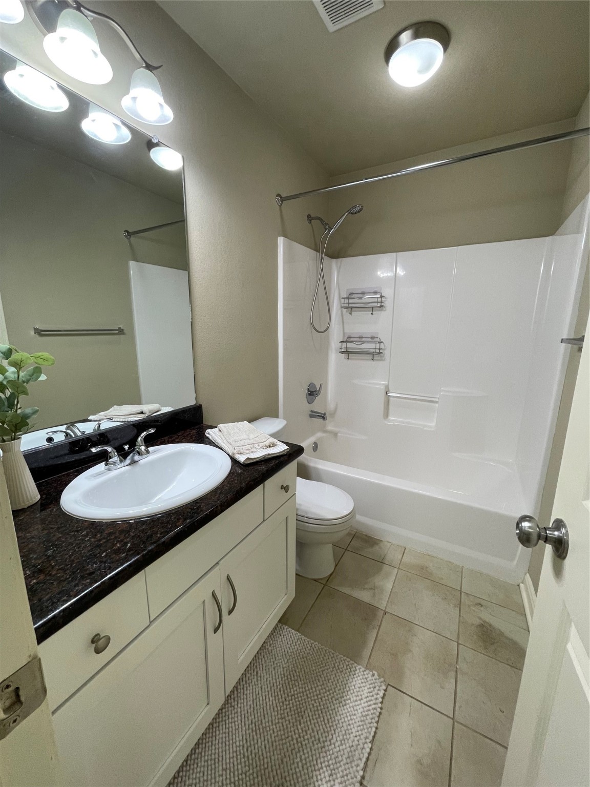 951 Oak Terrace Drive Conroe, TX 77378 - Photo 17 of 19 a bathroom with a granite countertop sink toilet mirror and a bathtub