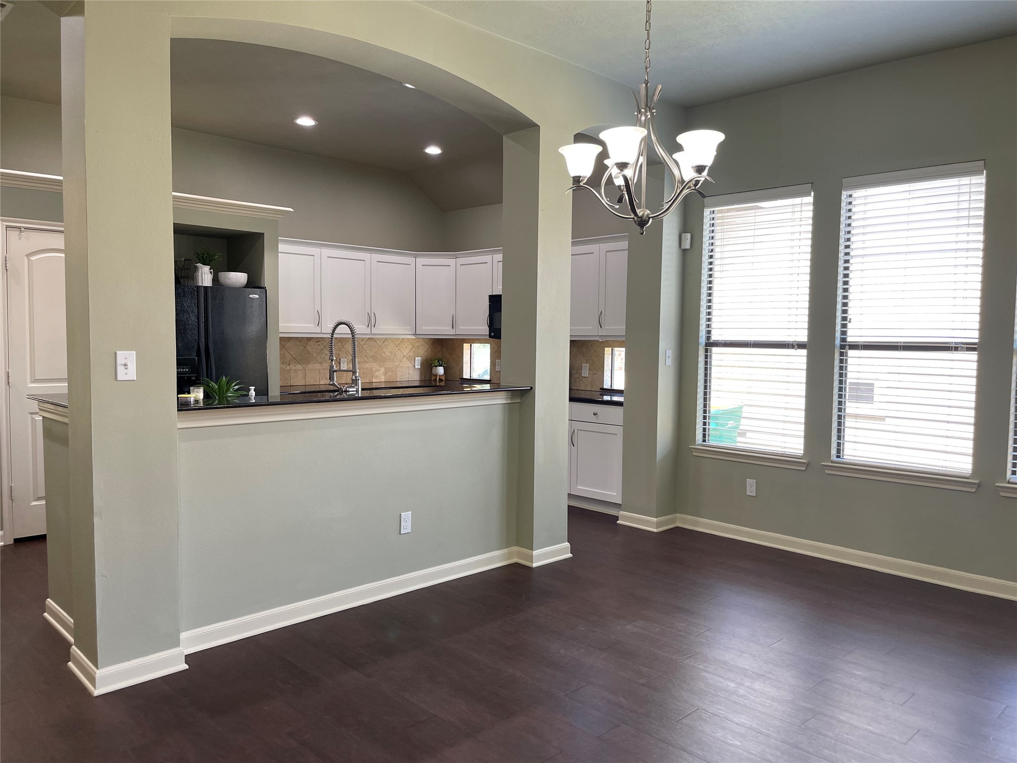 951 Oak Terrace Drive Conroe, TX 77378 - Photo 7 of 19 a room with kitchen island granite countertop a stove a sink a refrigerator and a large window