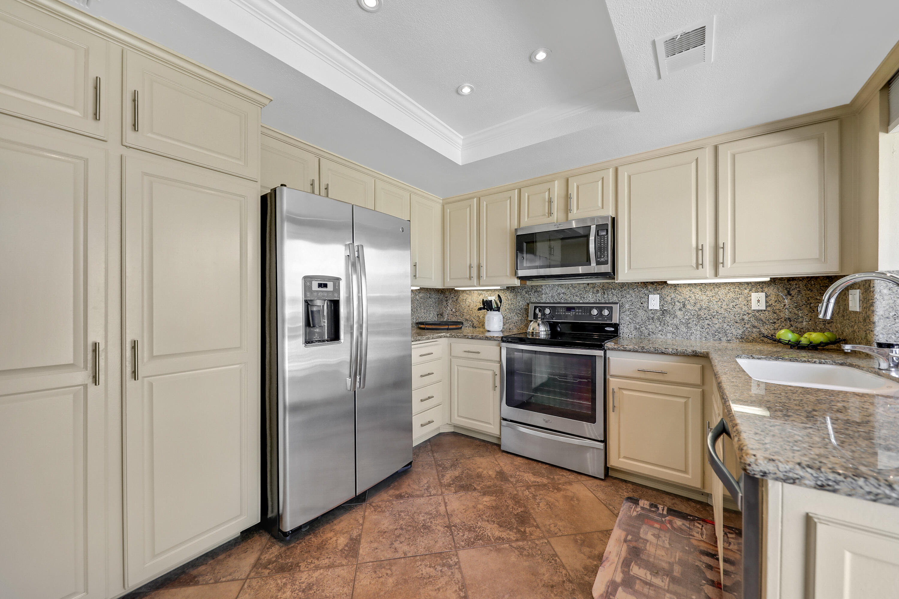 29 Leon Way Rancho Mirage, CA 92270 - Photo 11 of 17 a kitchen with granite countertop a refrigerator stove and microwave