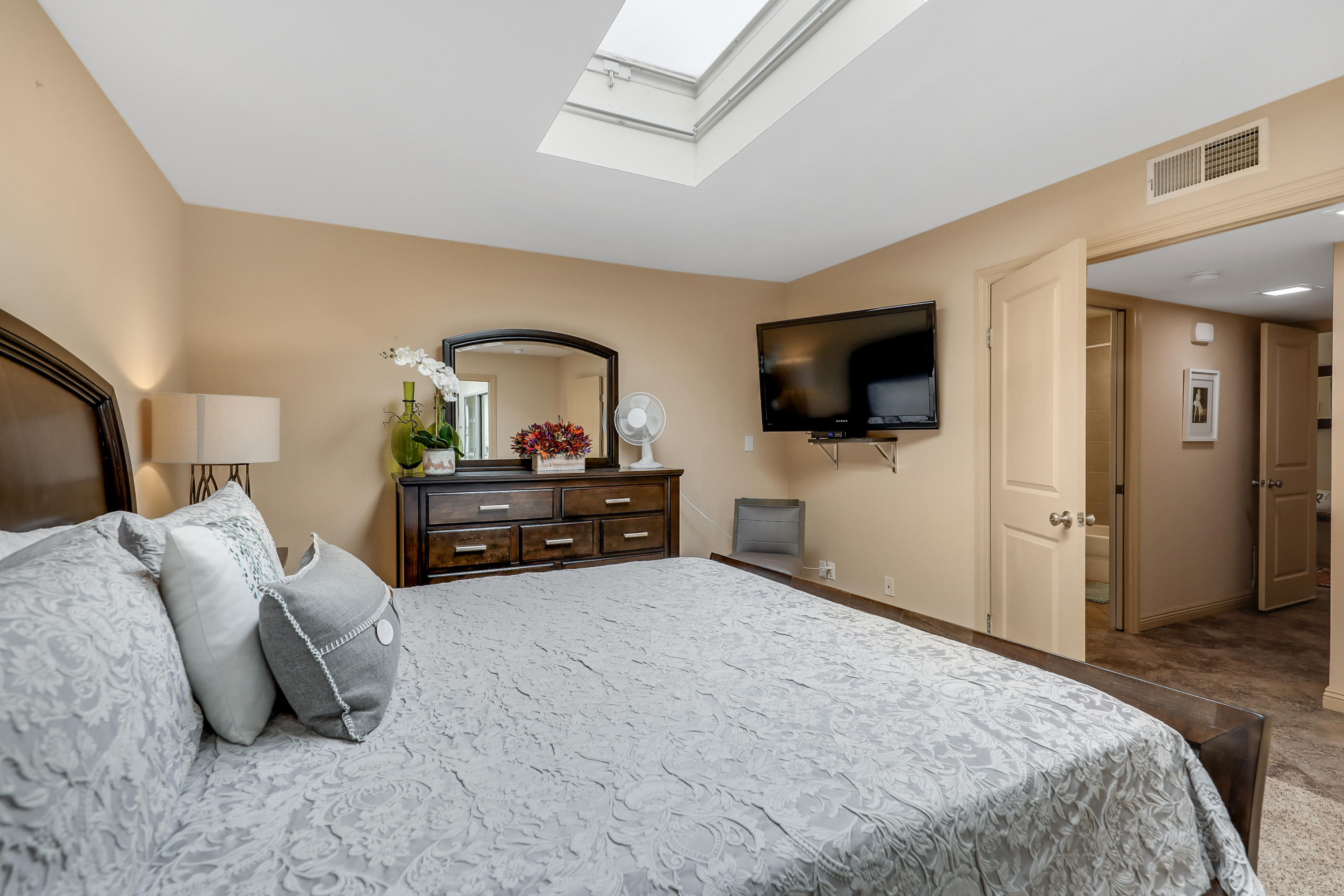 29 Leon Way Rancho Mirage, CA 92270 - Photo 13 of 17 a spacious bedroom with a bed and a flat screen tv