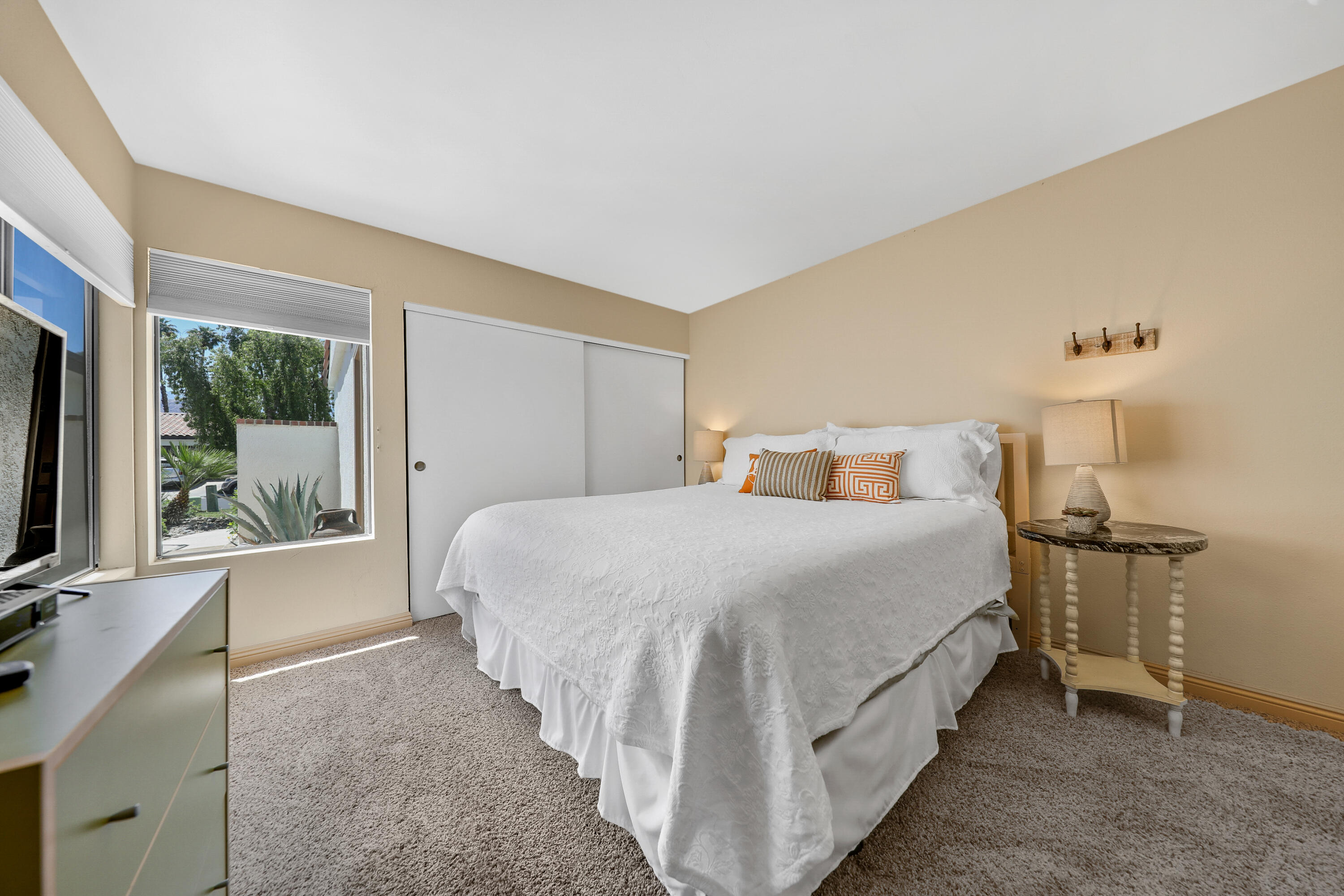 29 Leon Way Rancho Mirage, CA 92270 - Photo 15 of 17 a bedroom with a bed and a flat tv screen on dresser
